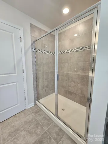 a bathroom with a glass shower door