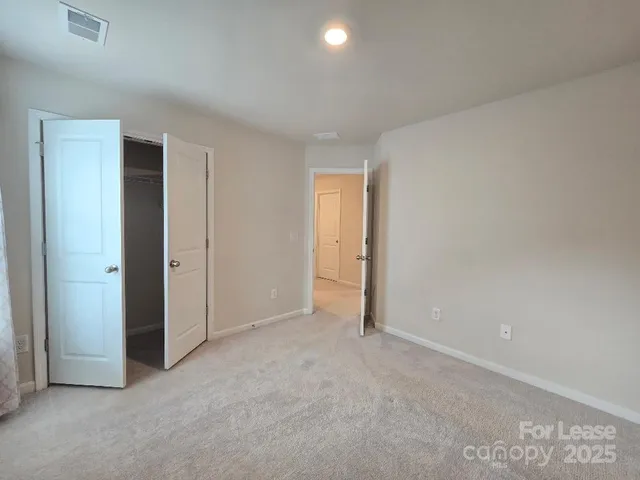 an empty room with closet area