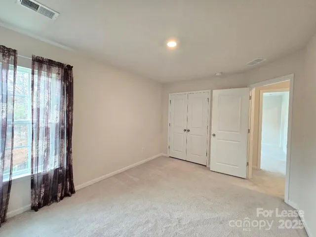 a view of an empty room and a window