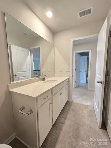 a spacious bathroom with a sink a mirror and a vanity