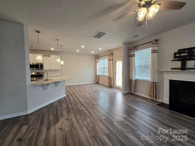a view of kitchen with cabinets and wooden floor