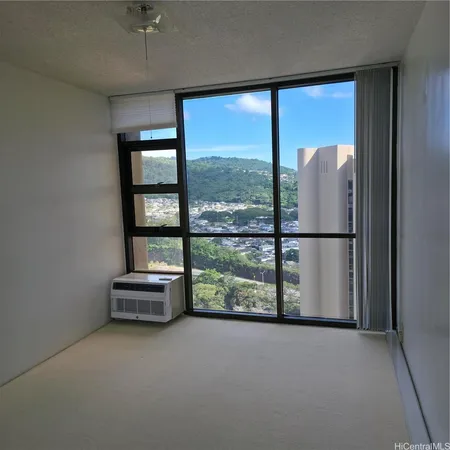 an empty room with sliding glass door and mountain view