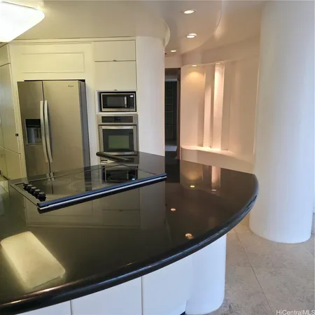 a view of a refrigerator a window in an empty room