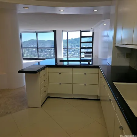 a kitchen with stainless steel appliances granite countertop a sink and a stove
