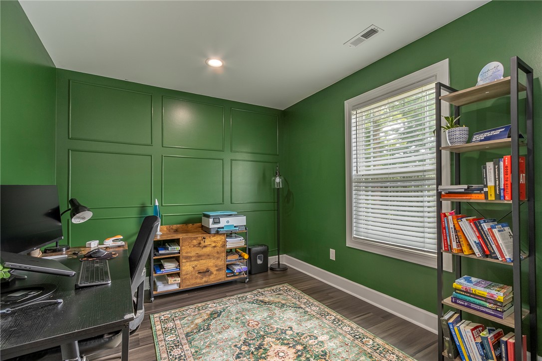 3080 McGee Road Iva, SC 29655 - Photo 15 of 49 Custom wall paneling and dark wood flooring create a stylish and productive home office atmosphere.
