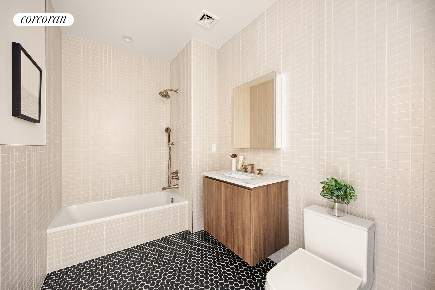 103 Putnam Avenue, Unit 1B Brooklyn, NY 11238 - Photo 12 of 13 a bathroom with a toilet a sink and bathtub