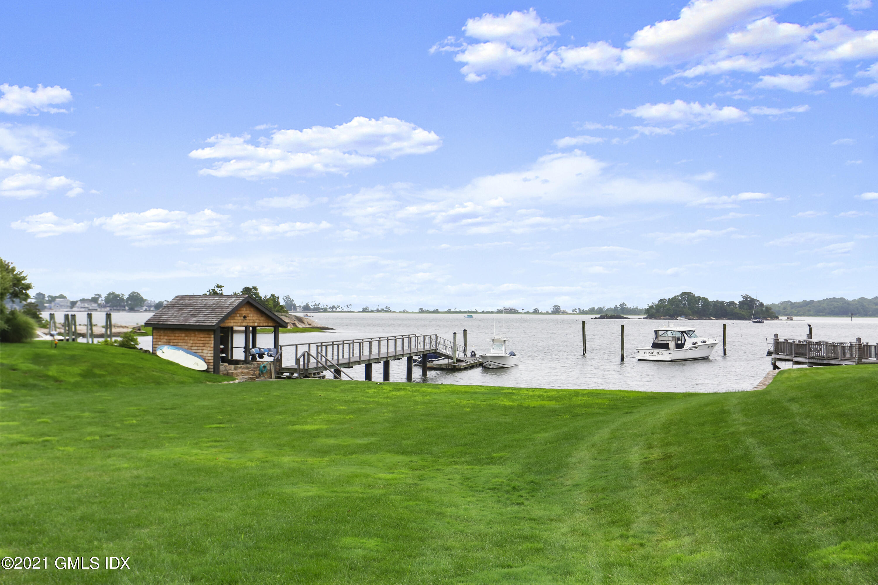 91 Indian Head Road Riverside, CT 06878 - Photo 1 of 45 a view of a lake with houses in back