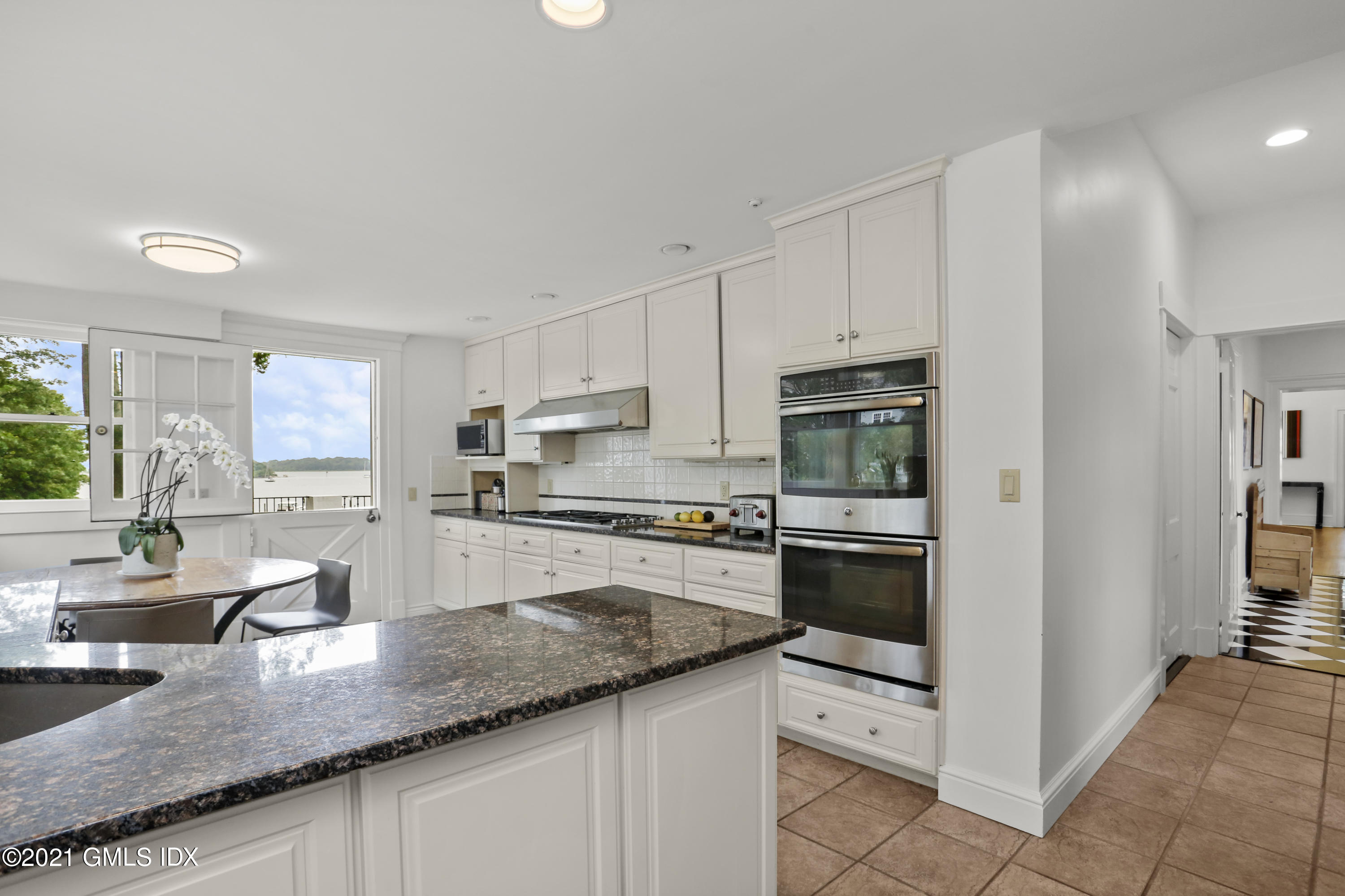 91 Indian Head Road Riverside, CT 06878 - Photo 13 of 45 a kitchen with stainless steel appliances granite countertop a stove top oven a sink and dishwasher