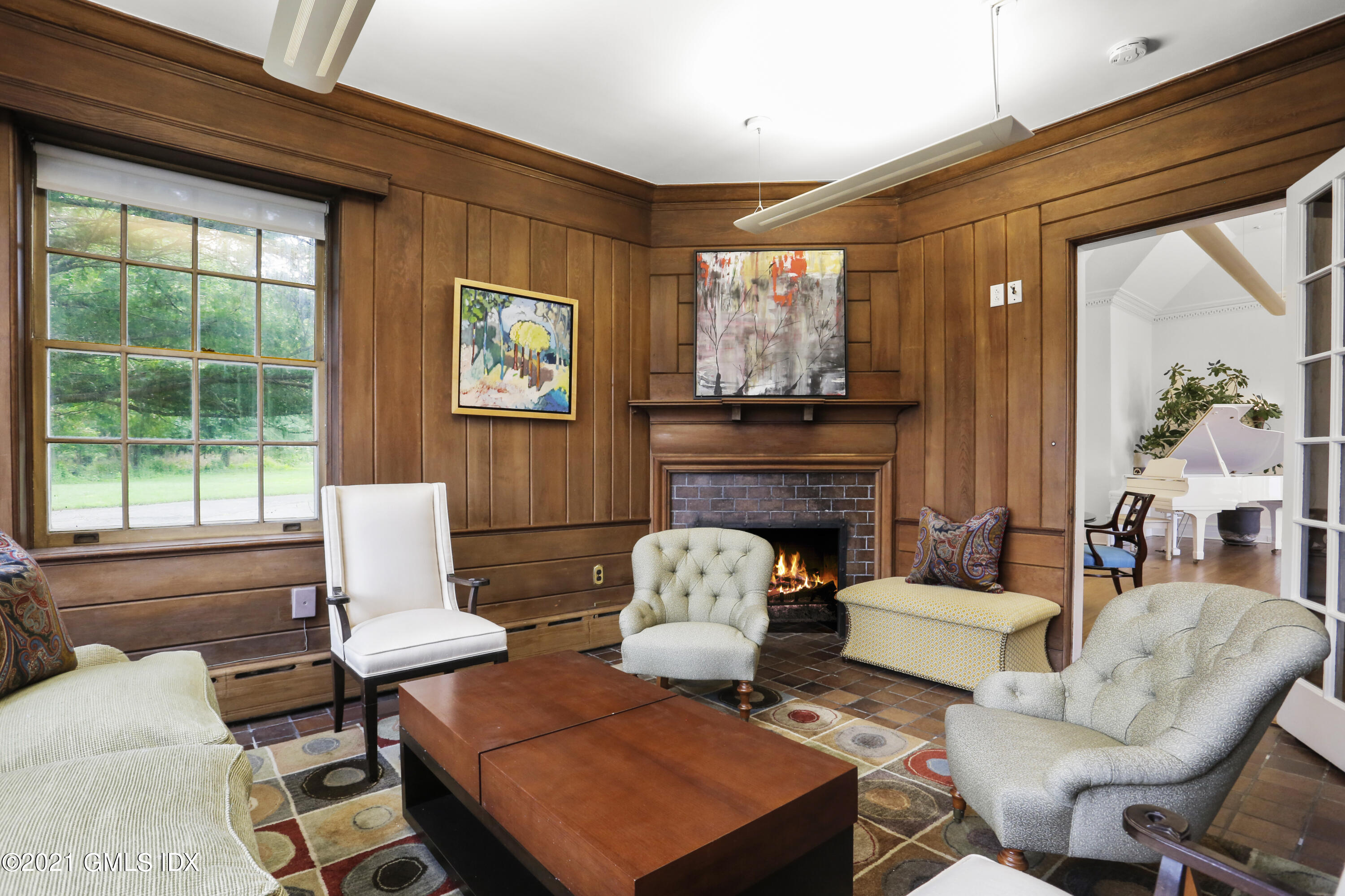 91 Indian Head Road Riverside, CT 06878 - Photo 16 of 45 a living room with fireplace furniture and a large window