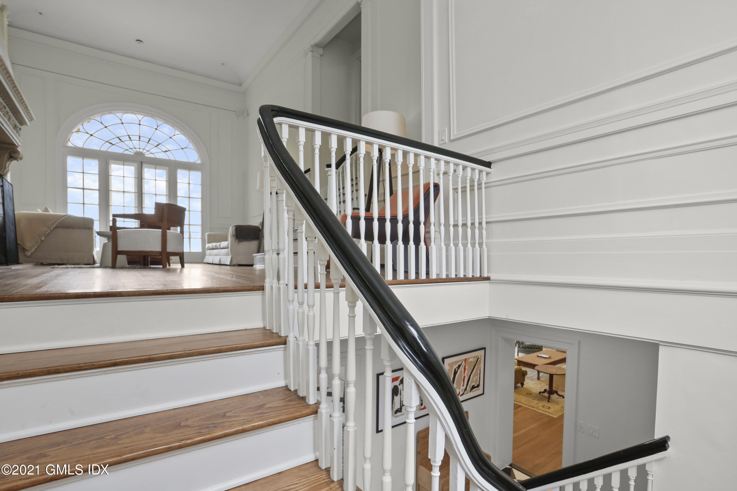 91 Indian Head Road Riverside, CT 06878 - Photo 21 of 45 a view of staircase with lots of frames on wall and a view of staircase