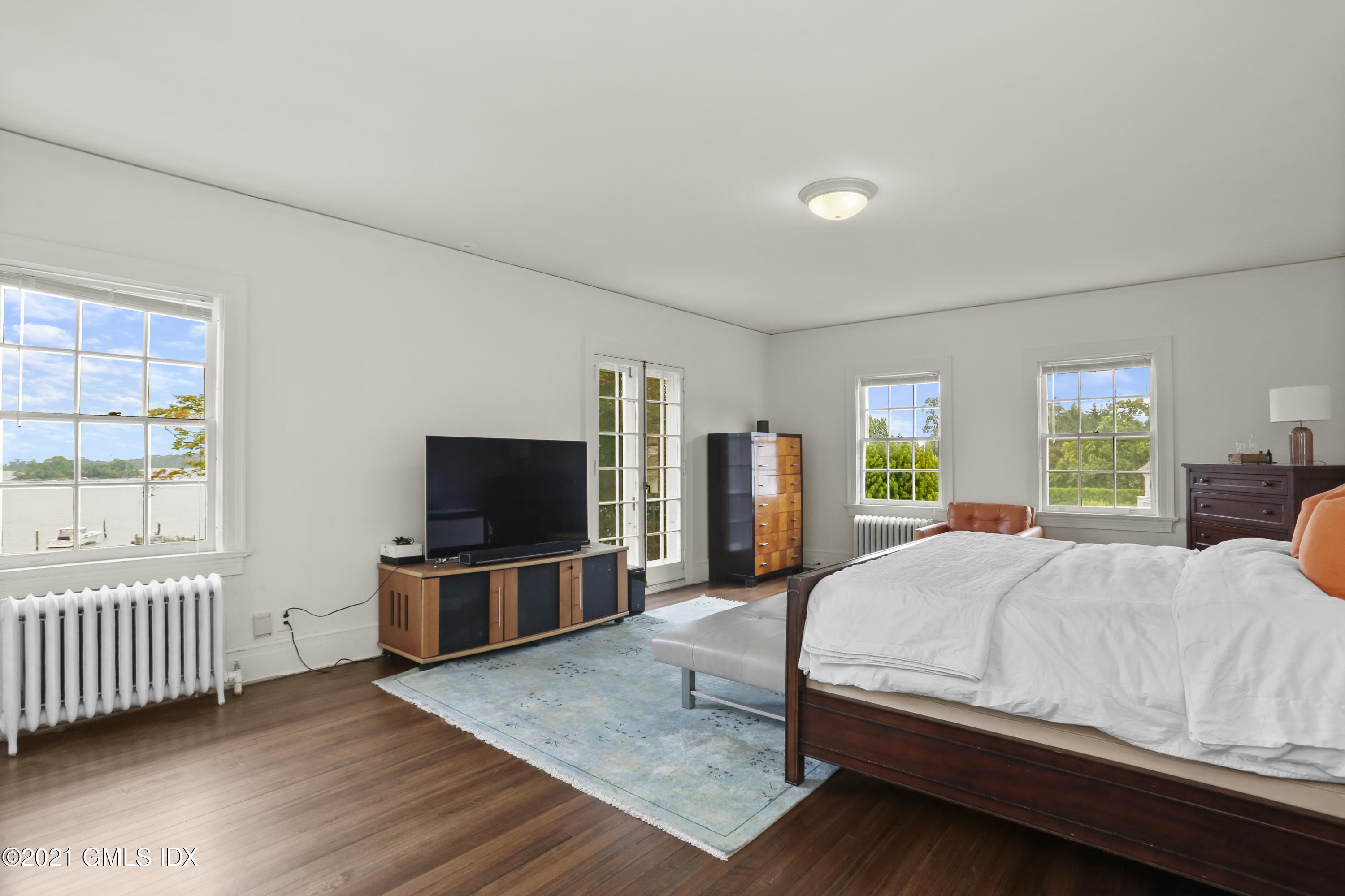91 Indian Head Road Riverside, CT 06878 - Photo 26 of 45 a bedroom with a bed and a flat screen tv