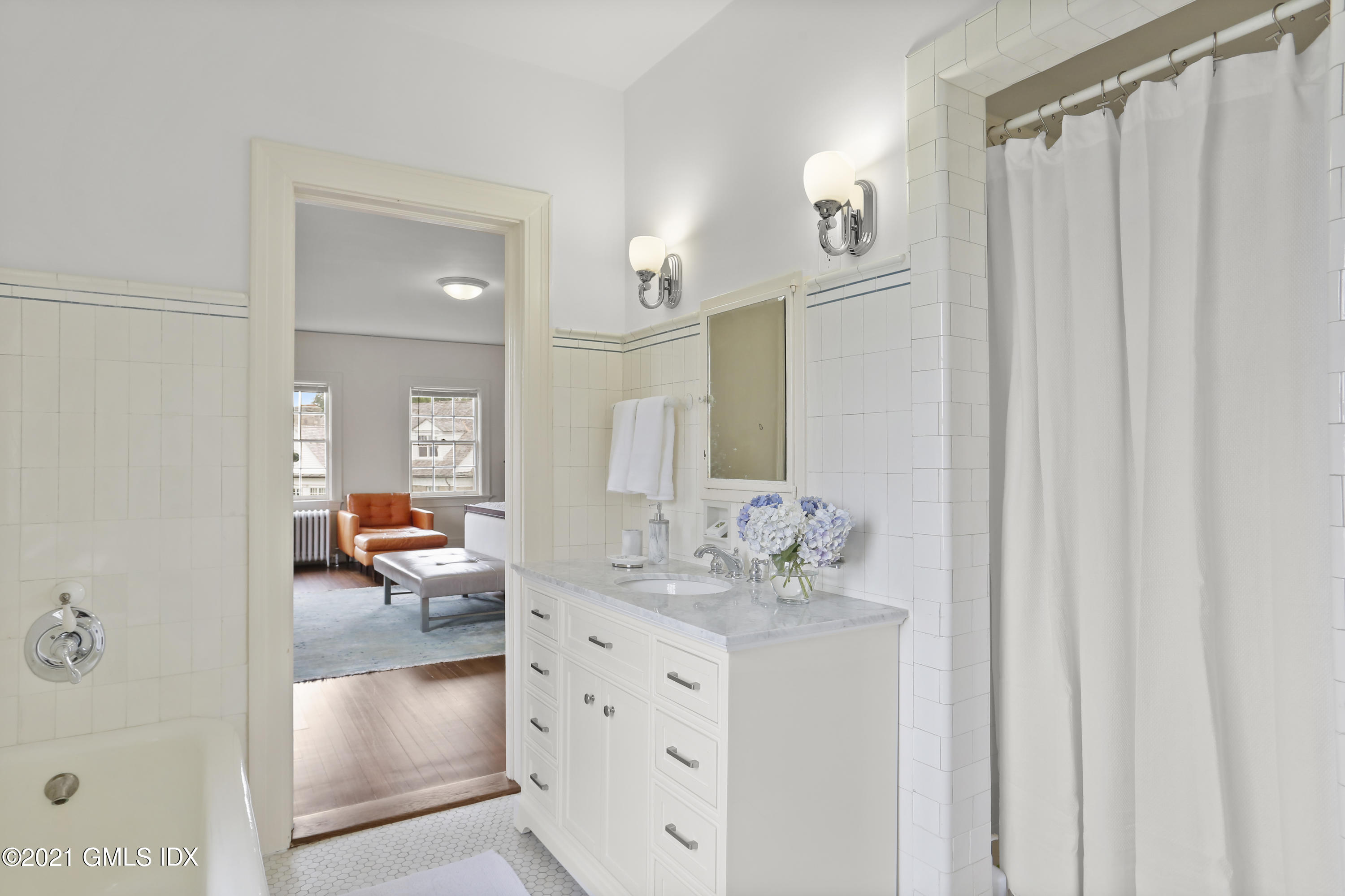 91 Indian Head Road Riverside, CT 06878 - Photo 29 of 45 a bathroom with a double vanity sink and a mirror