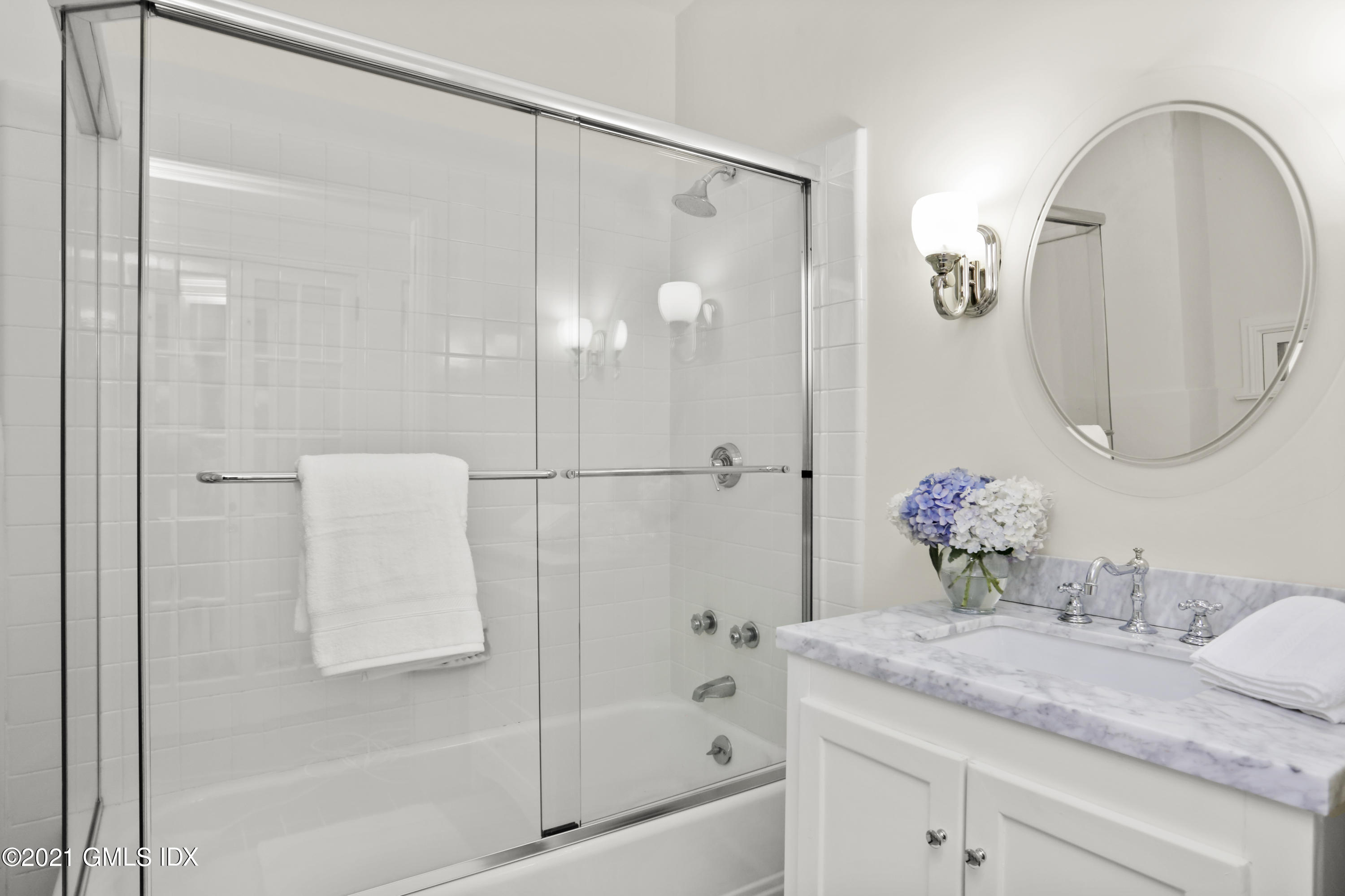 91 Indian Head Road Riverside, CT 06878 - Photo 33 of 45 a bathroom with a granite countertop sink a mirror and shower