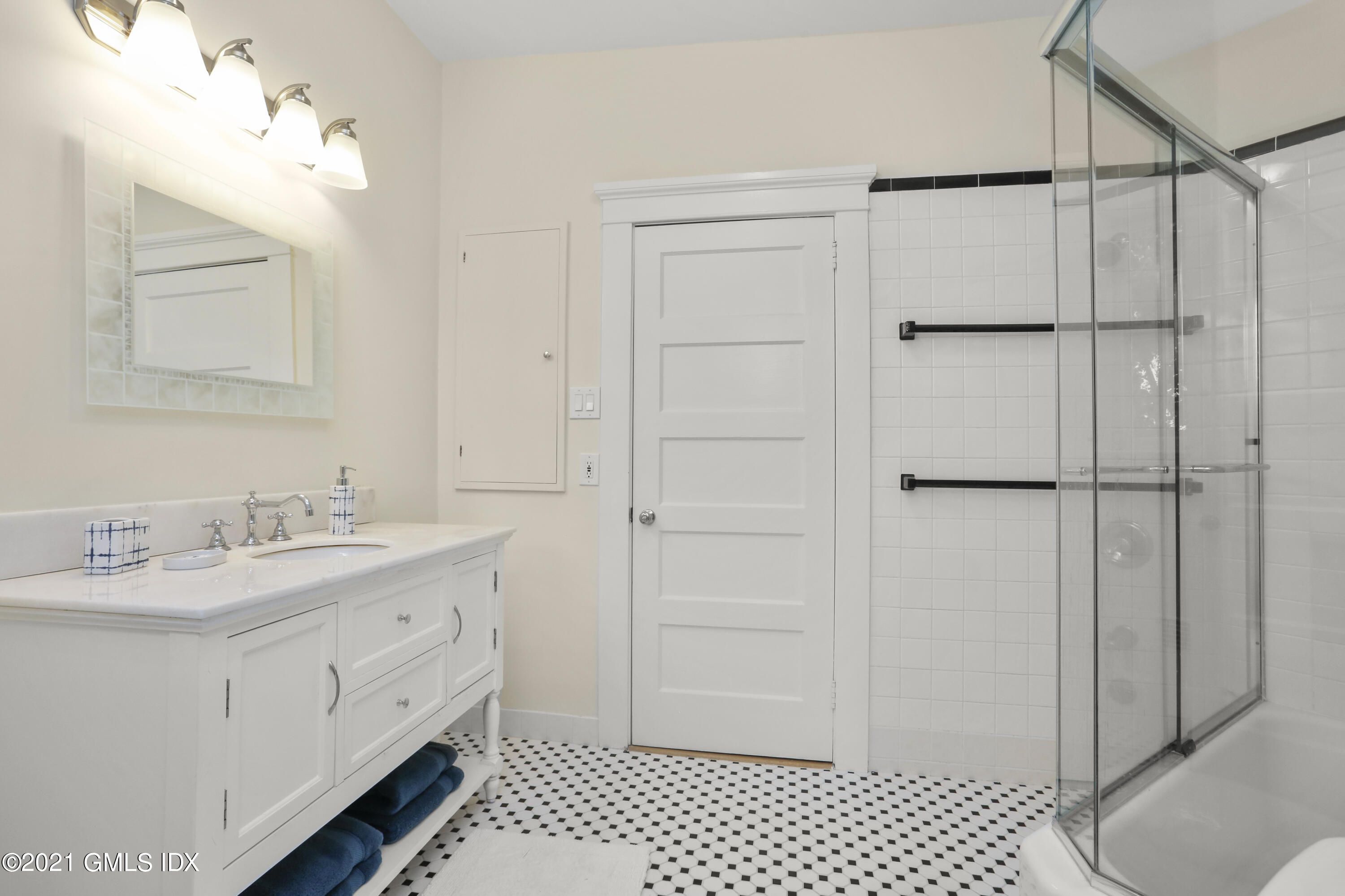 91 Indian Head Road Riverside, CT 06878 - Photo 35 of 45 a bathroom with a double vanity sink and mirror
