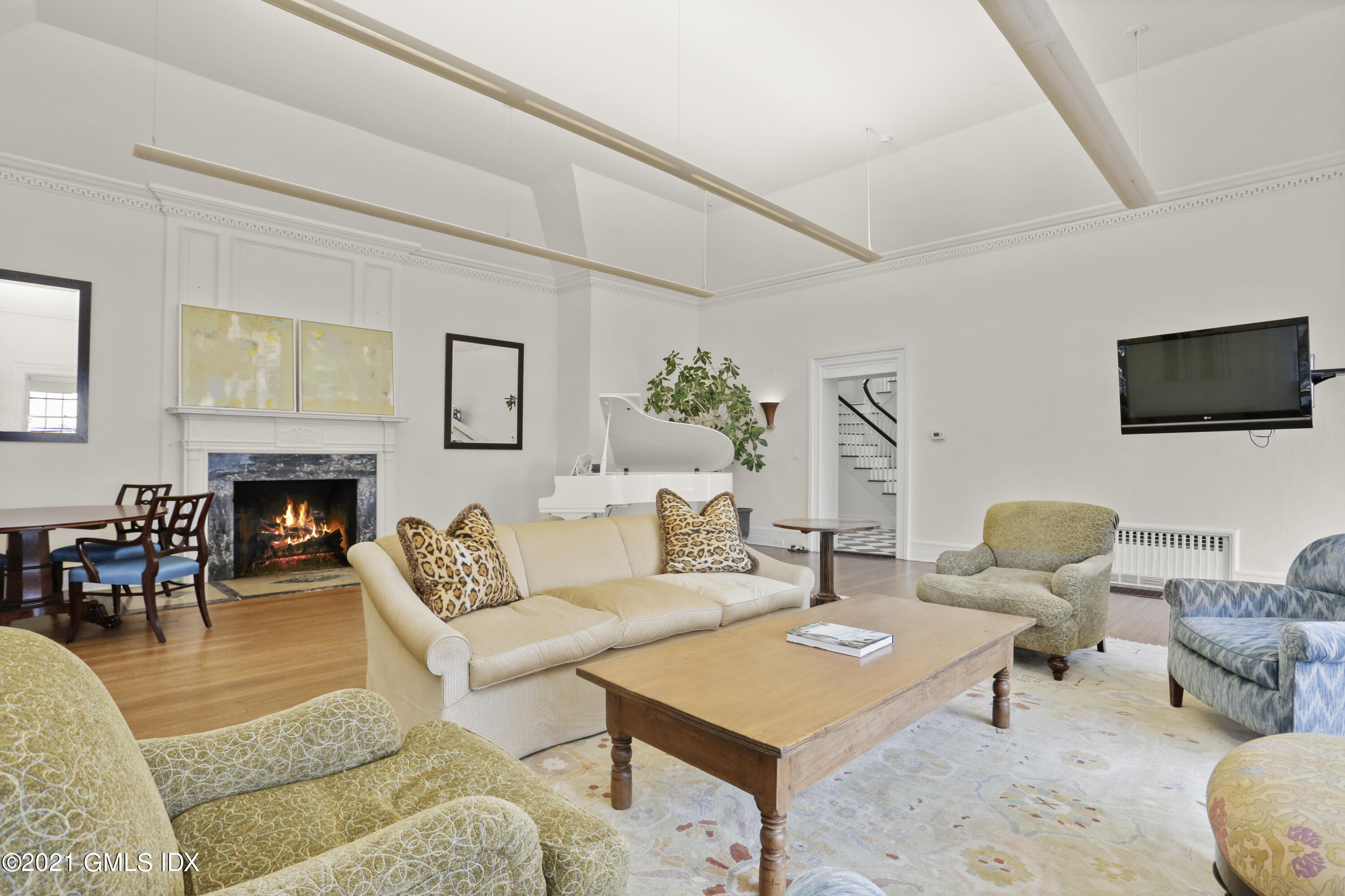 91 Indian Head Road Riverside, CT 06878 - Photo 9 of 45 a living room with furniture a flat screen tv and a fireplace