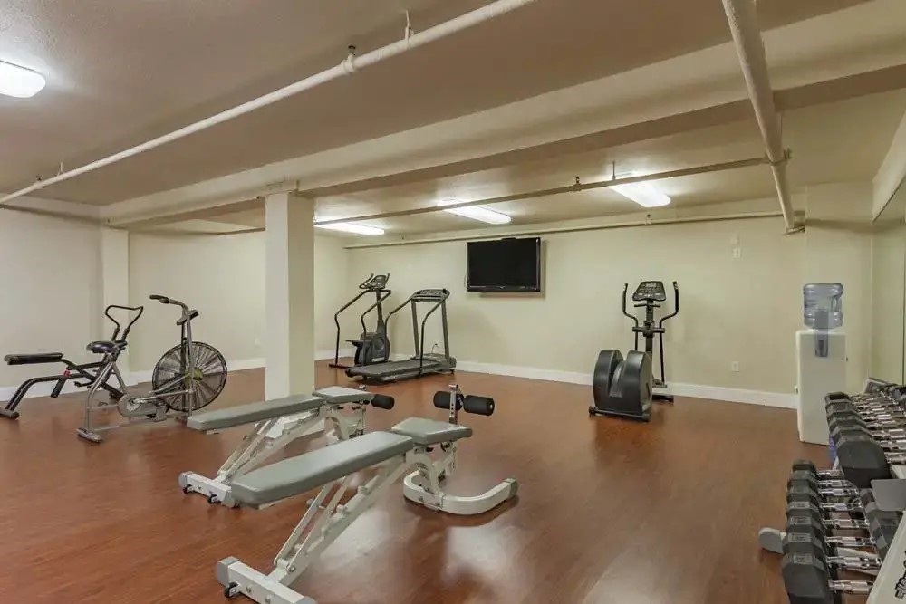 312 Court Street The Dalles, OR 97058 - Photo 13 of 19 a room with gym equipment and view of living room