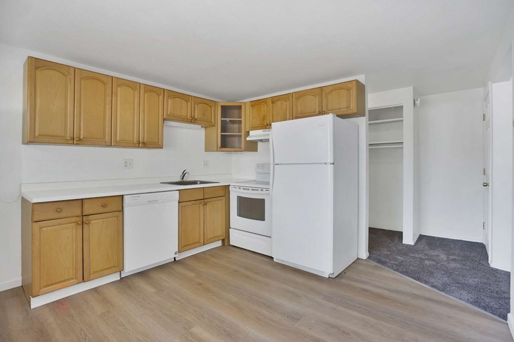 269 Chicopee Street, Unit 17 Chicopee, MA 01013 - Photo 2 of 19 a kitchen with wooden cabinets and white appliances