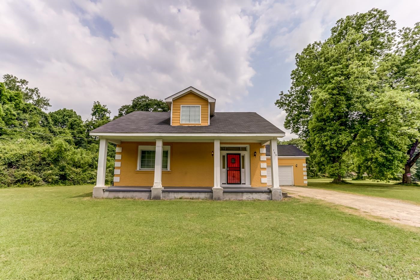 a front view of house with yard and green space