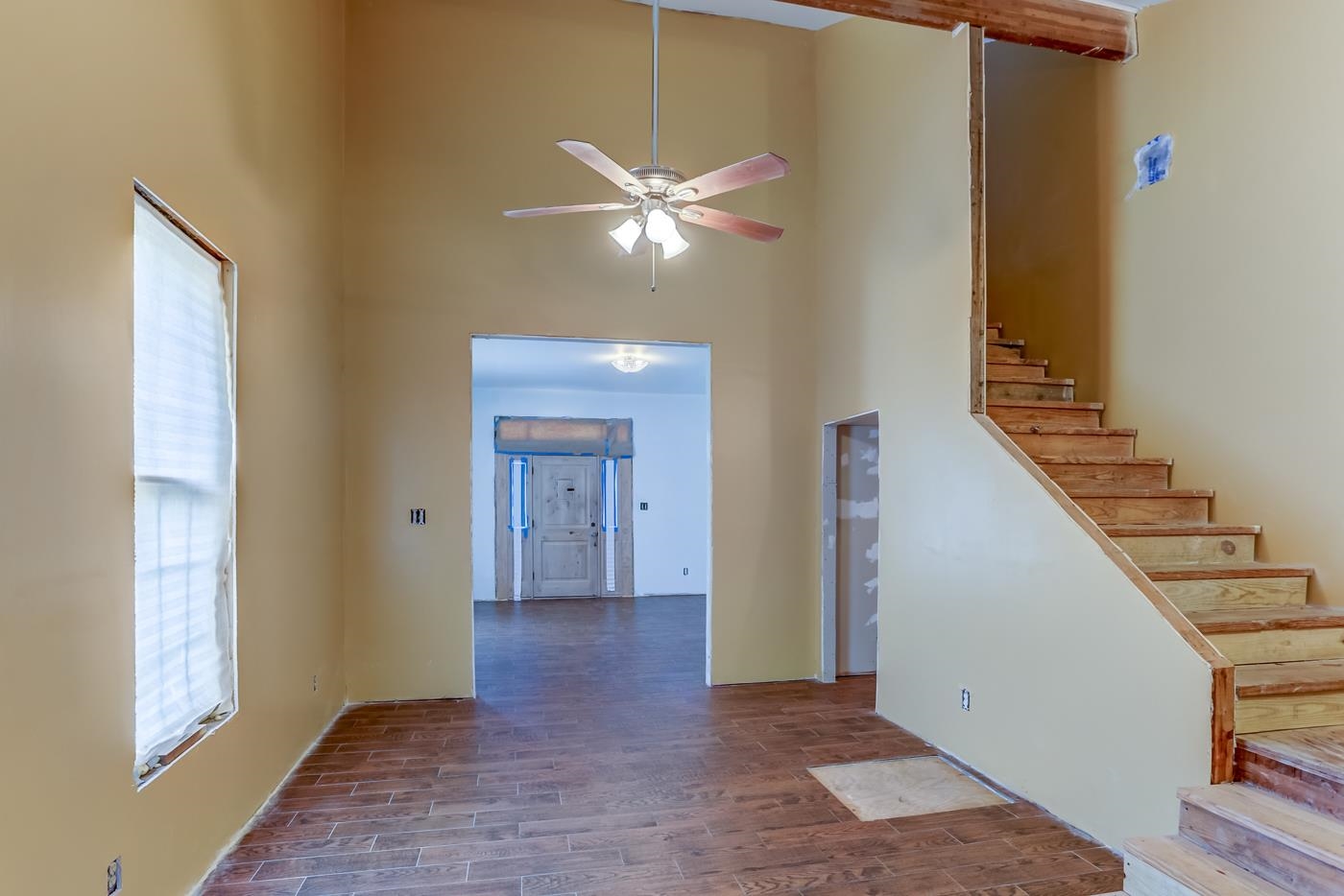 760 Craft Road Memphis, TN 38116 - Photo 11 of 25 a view of an empty room with wooden floor and a ceiling fan