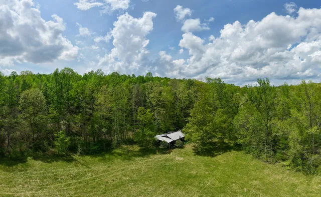 a backyard of a house with barbeque oven table and chairs