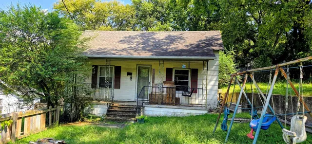 a view of a house with a yard and plants