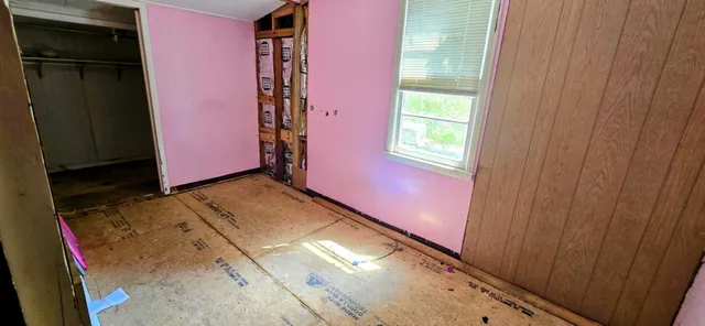 a room with furniture a flat screen tv and a window