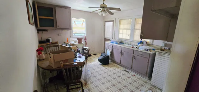 a view of a chairs and tables in the back yard of the house