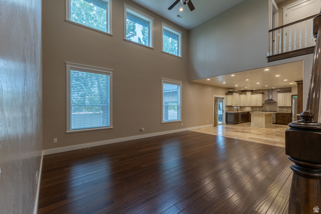 3565 West 1350th Street North Vernal, UT 84078 - Photo 8 of 54 Expansive interior featuring high ceilings, dark wood-finish flooring, and a multi-level window arrangement