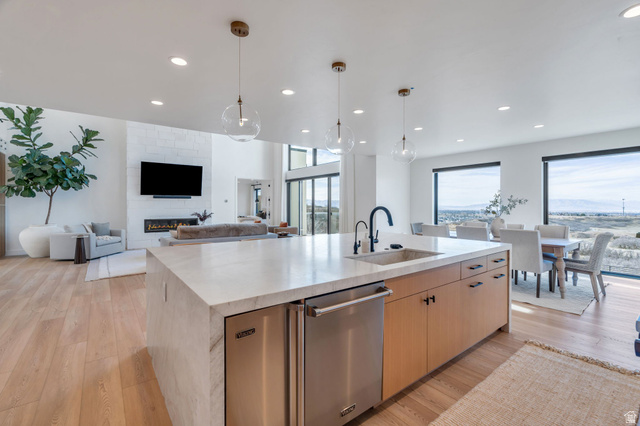 3918 South Mapleton Ests Drive Mapleton, UT 84664 - Photo 18 of 103 Kitchen with an island with sink, light stone counters, light wood-type flooring, and stainless steel dishwasher