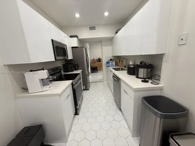a kitchen with a sink a stove and refrigerator