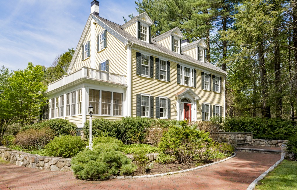 a front view of a house with garden and porch