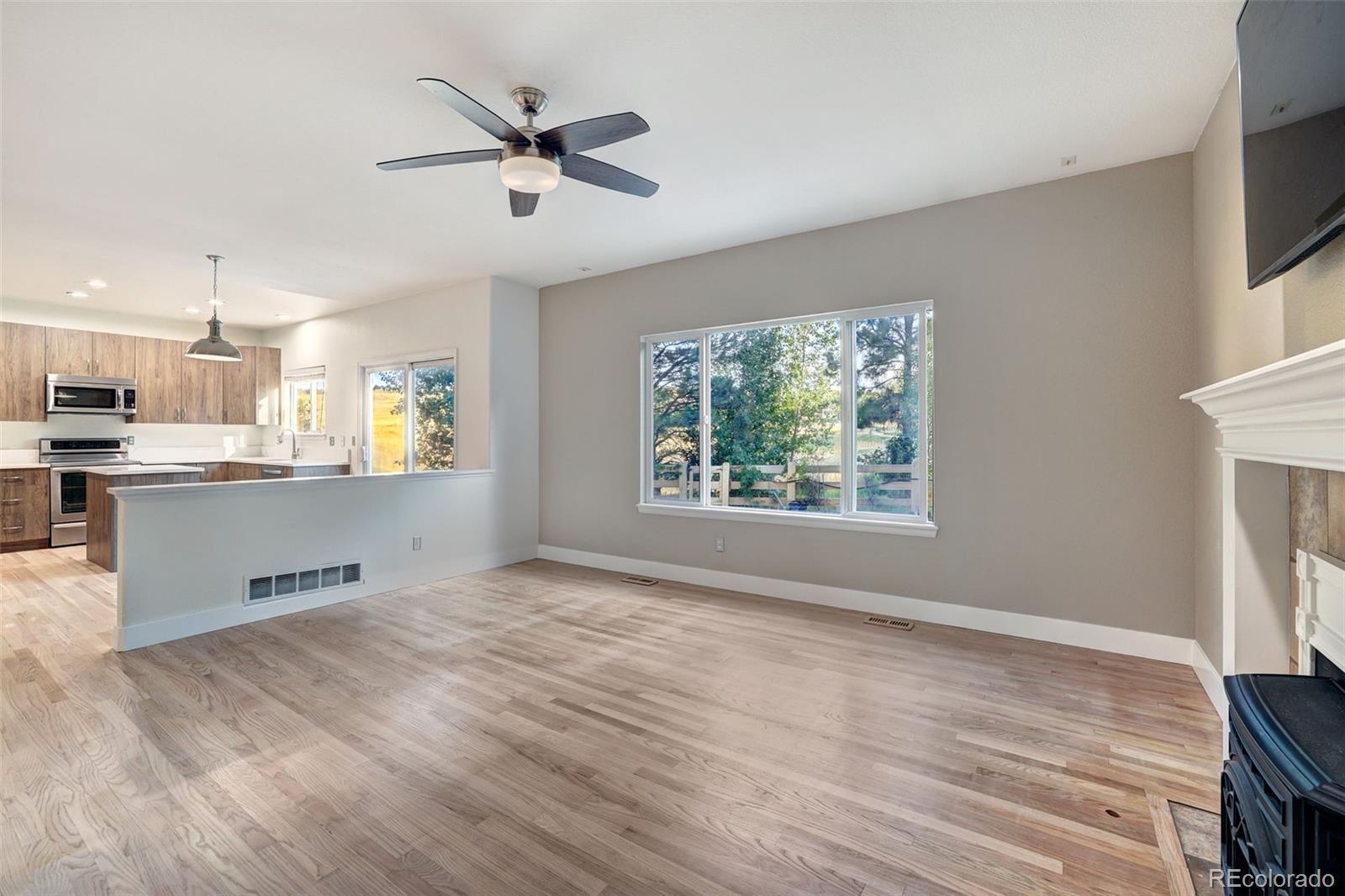 3232 Cimarron Place Superior, CO 80027 - Photo 13 of 43 a view of an empty room with window and wooden floor