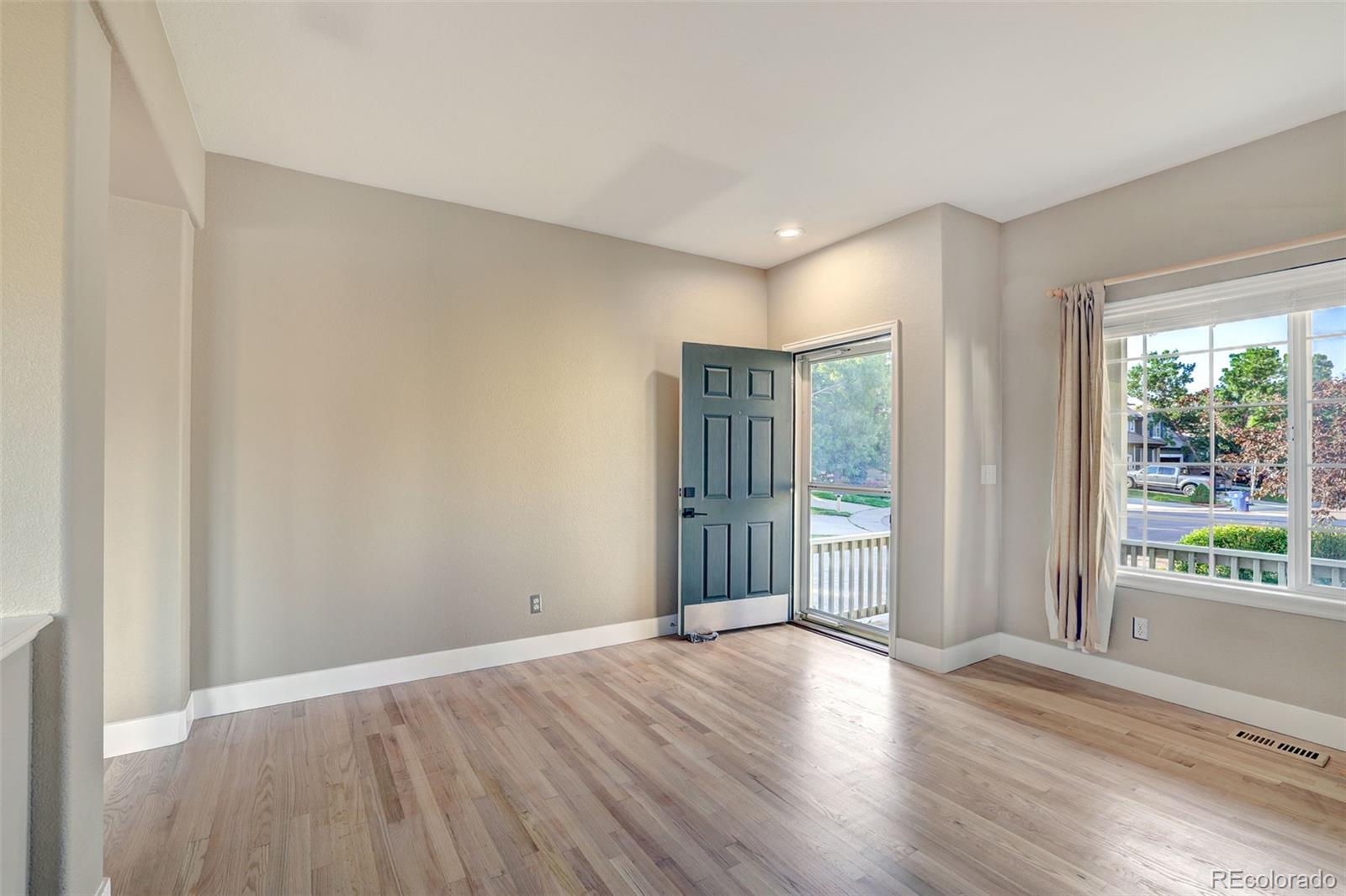 3232 Cimarron Place Superior, CO 80027 - Photo 15 of 43 a view of an empty room with wooden floor and a window