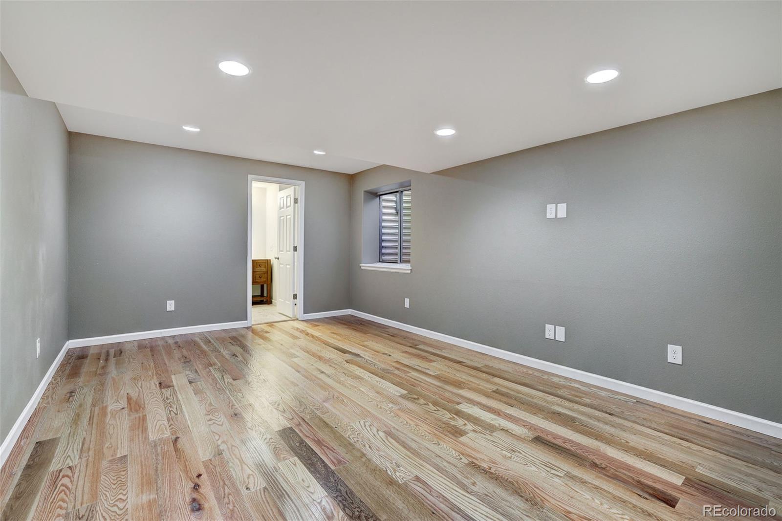 3232 Cimarron Place Superior, CO 80027 - Photo 33 of 43 a view of an empty room with wooden floor and a window