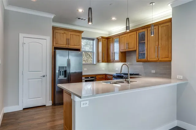 a kitchen that has a sink and a stove in it