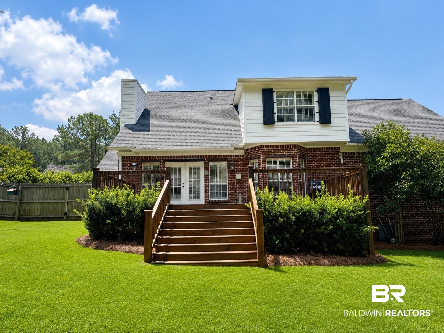 103 Raphael Semmes Drive East Spanish Fort, AL 36527 - Photo 6 of 9 Expansive backyard featuring a lush lawn and a wood deck with stairs