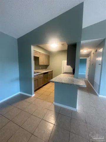 a large kitchen with kitchen island granite countertop a large counter top and appliances