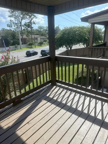a view of a balcony with wooden floor
