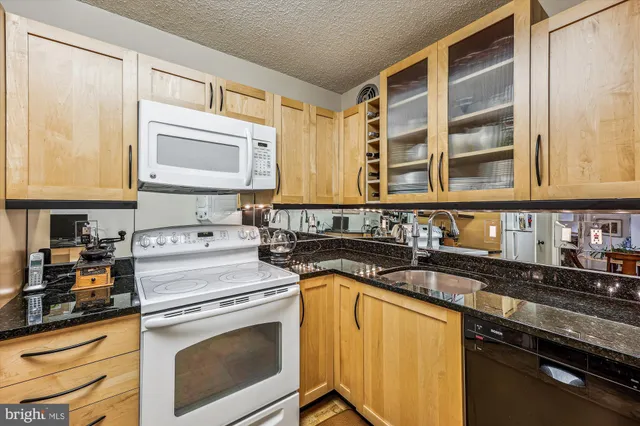 a kitchen with stainless steel appliances granite countertop a stove and cabinets