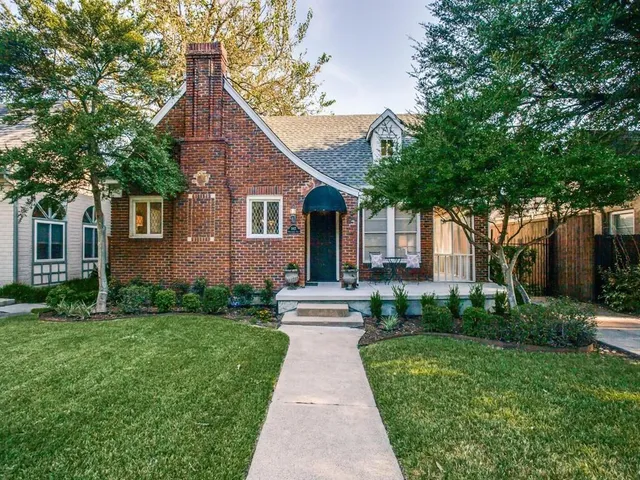 a front view of a house with yard and green space