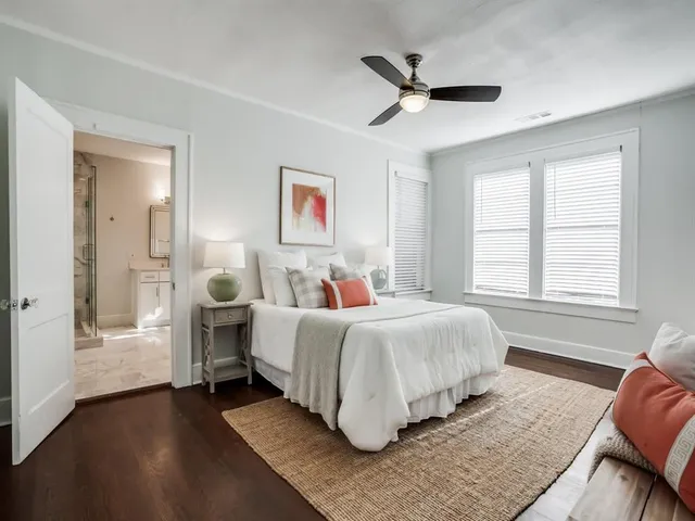 a spacious bedroom with a bed and a window