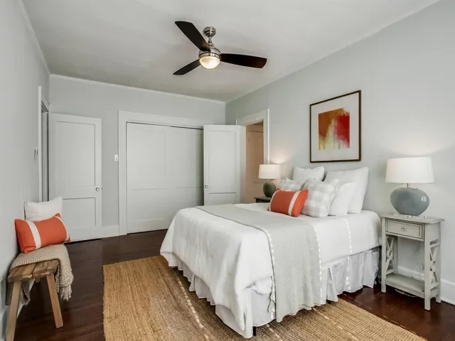 a bedroom with a bed and wooden floor