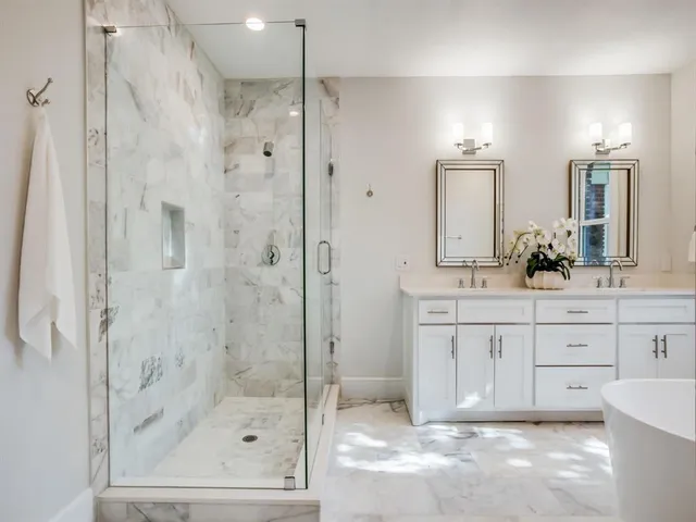 a bathroom with a shower sink and mirror