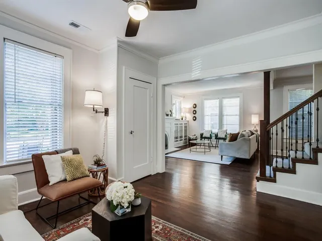 a living room with furniture and wooden floor