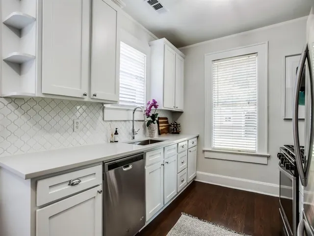 a kitchen with a white cabinets and sink