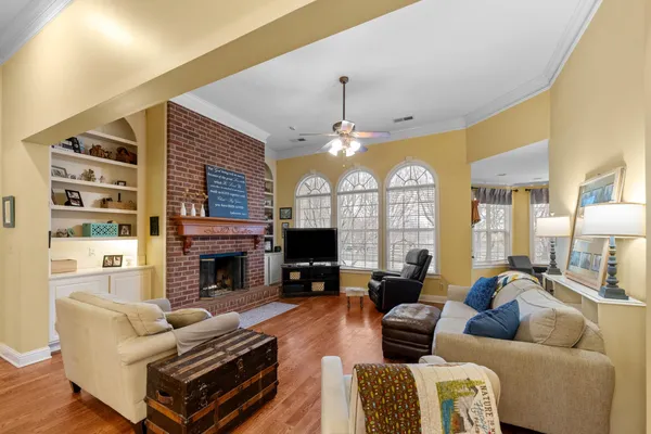 a living room with furniture fireplace and flat screen tv