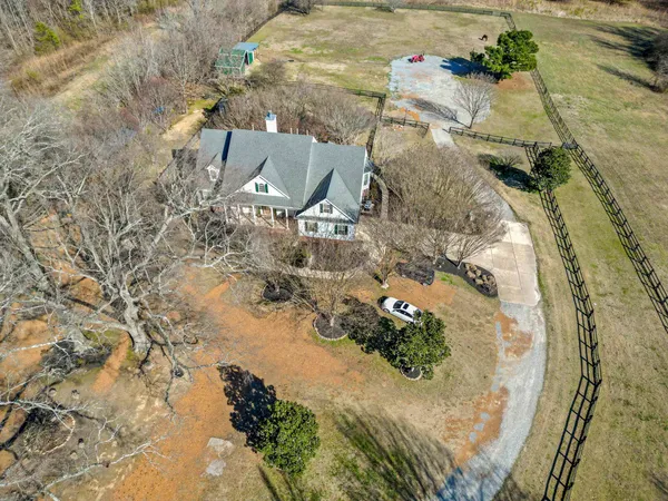 a bedroom with furniture and a large window