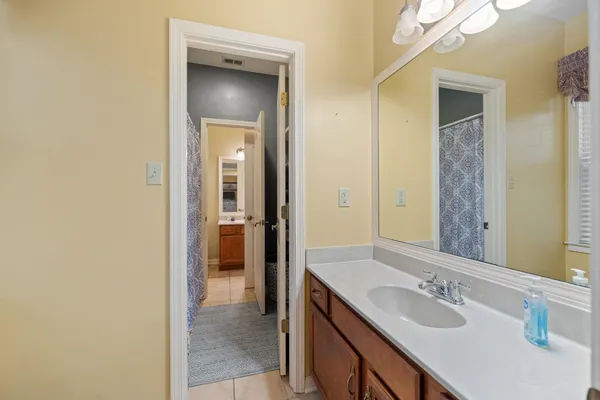 a en suite bathroom with a sink and a mirror