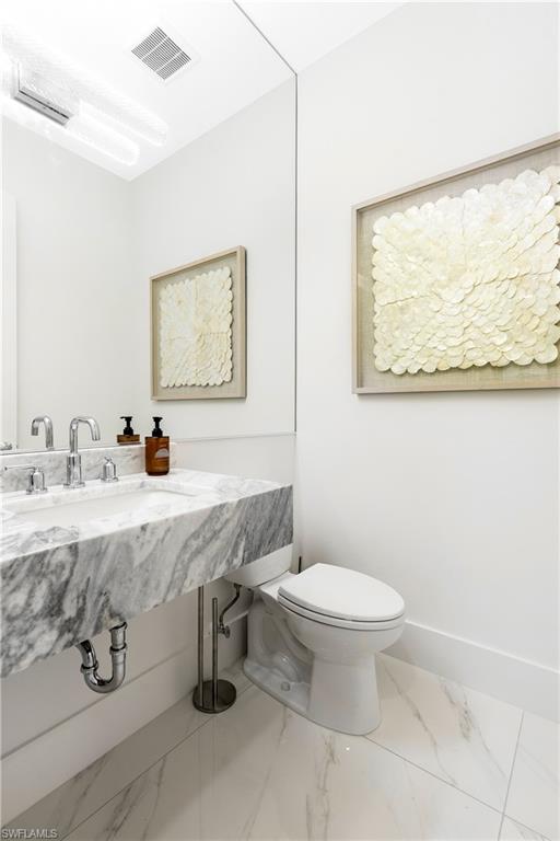 9675 Moonflower Court Naples, FL 34114 - Photo 19 of 32 Bathroom featuring marble finish floors and baseboards