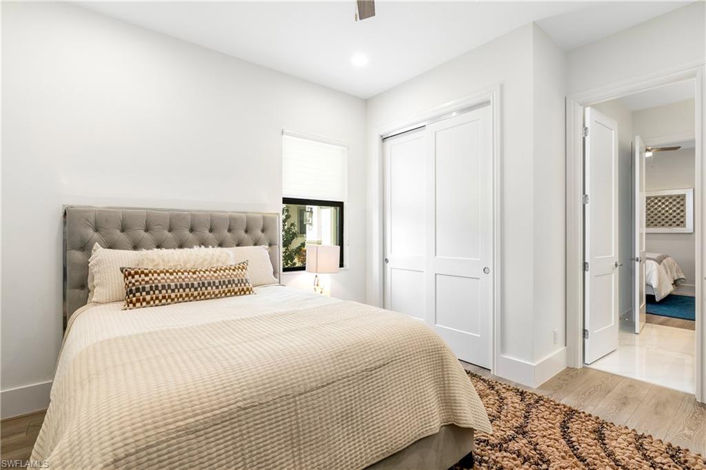 9675 Moonflower Court Naples, FL 34114 - Photo 20 of 32 Bedroom featuring wood finished floors, a closet, a ceiling fan, and recessed lighting